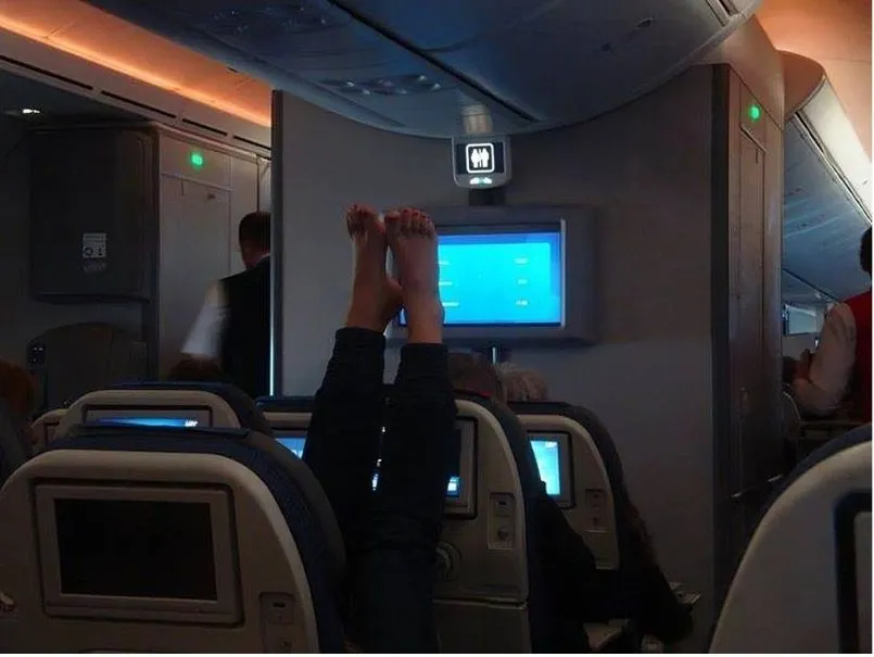 19. The girl lifted her legs above the head of another passenger.jpg?format=webp