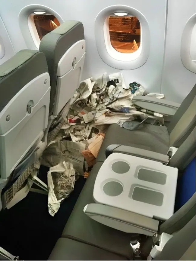 38. Someone made a mess with newspapers on the plane.jpg?format=webp